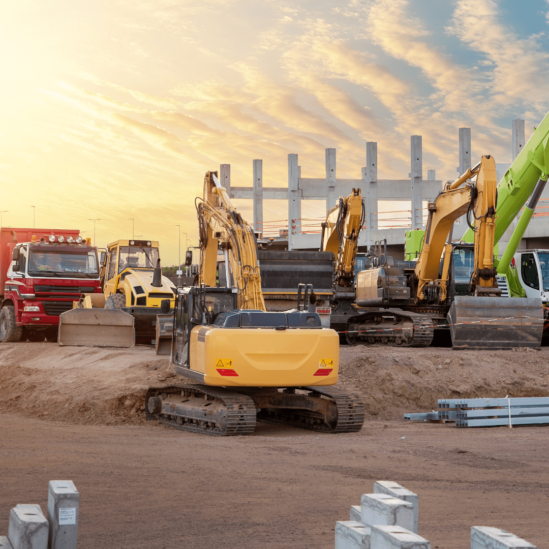Construction site with excavators and trucks under a clear sky