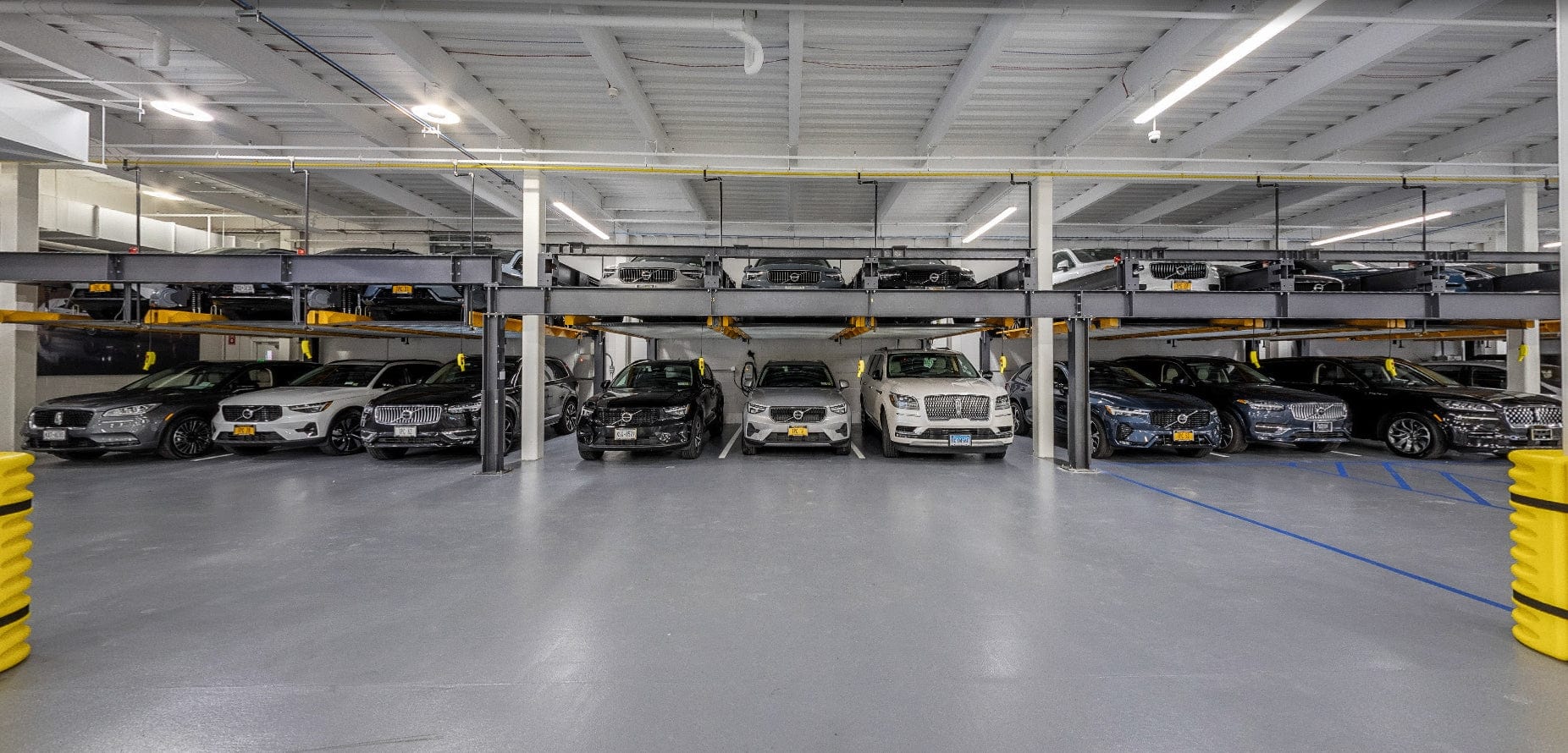 Multilevel clearspan parking garage with cars parked in designated spaces.